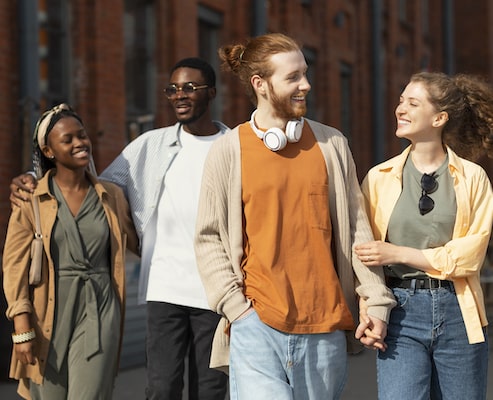 group of young adults smiling on the street